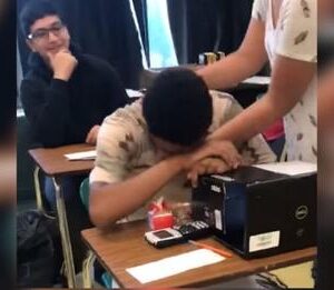 Struggling boy opens backpack teen girl put on his desk and quickly drops head down