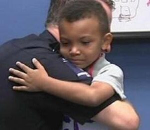 5-yr-old steps into police station with a sign – Officers See two words On It